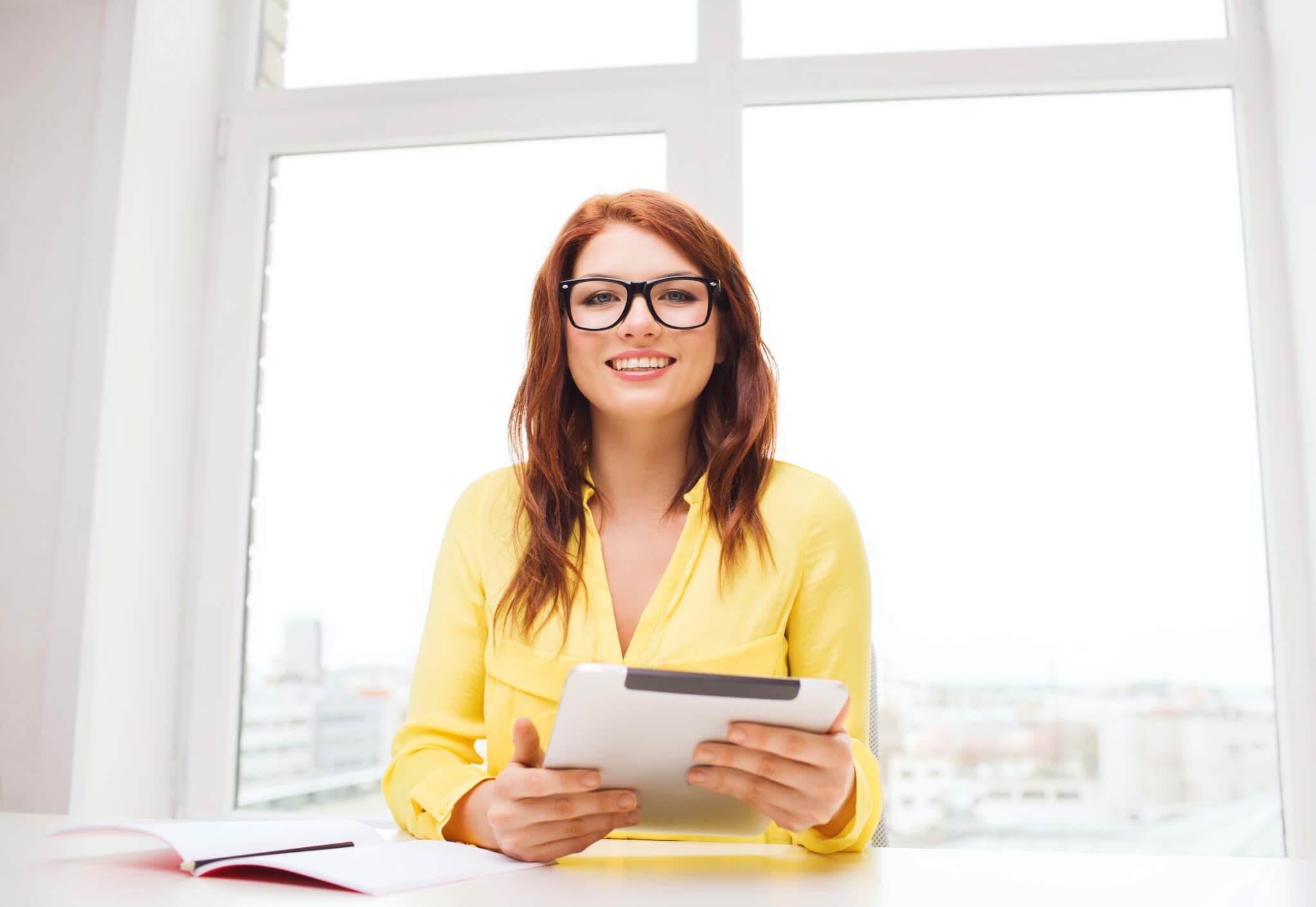 smiling businesswoman or student with tablet pc