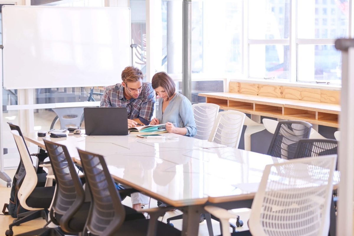 Business man and woman working together in conference room